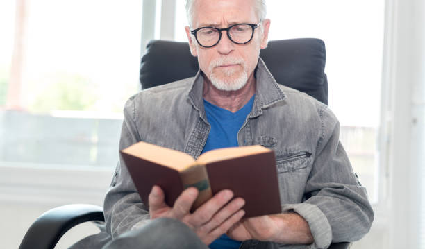 istock Portrait of mature man reading a book 896093184