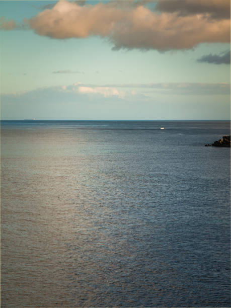 istock calm ocean surface with refelexions of the clouds during the evening 896093320