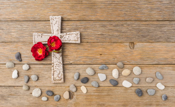 istock Stone cross with flowers for obituary death background 896093452