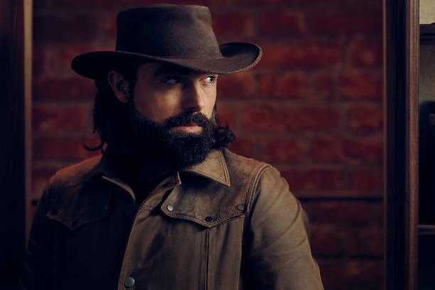 Handsome Man Wearing Cowboy hat in western style portrait