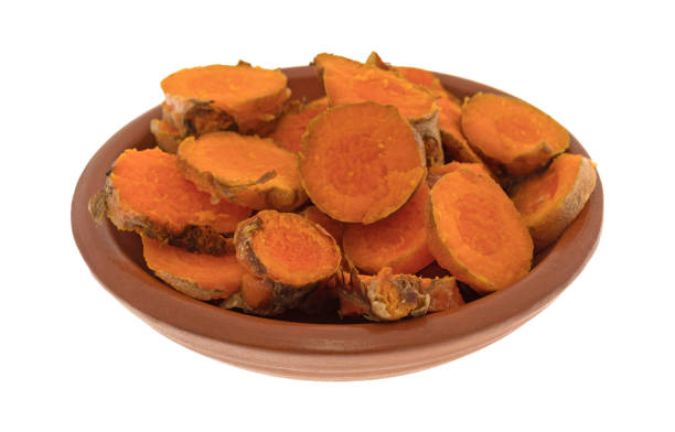 istock Slices of freshly cut turmeric in a small bowl 896105174
