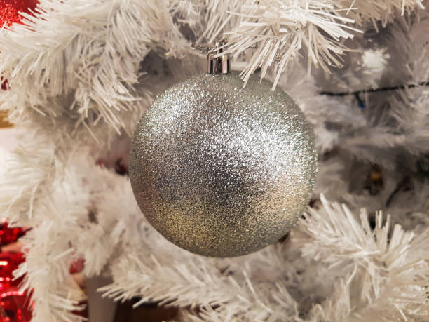 White Christmas ball hanging on Christmas tree