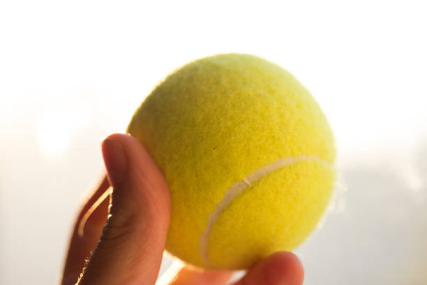 istock tenis ball in hand 896137422