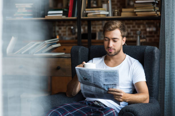 istock man reading newspaper at home 896139492