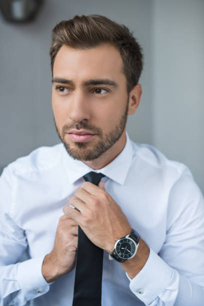 istock businessman straightening tie 896141660