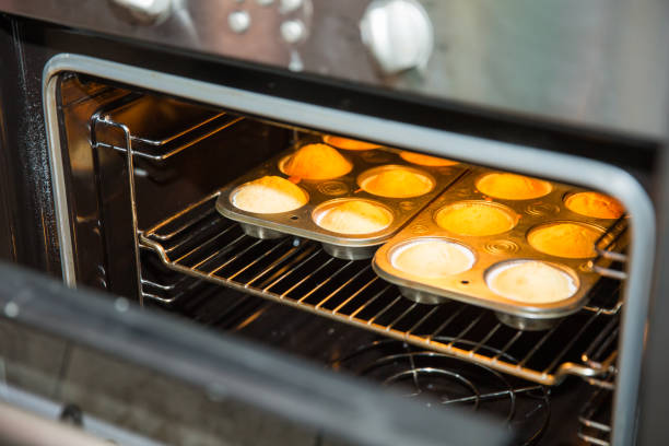 istock muffins on a baking tray in the oven 896141832