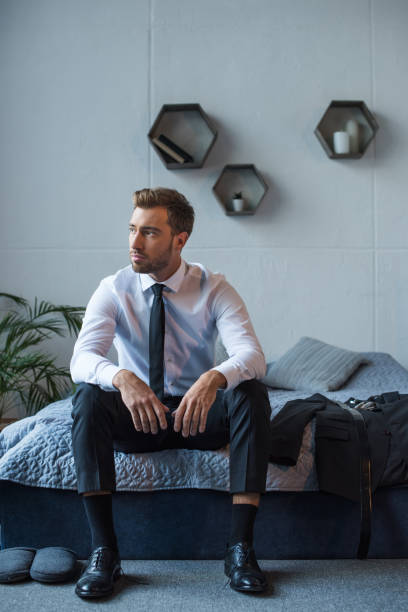 istock Businessman sitting on bed 896144598