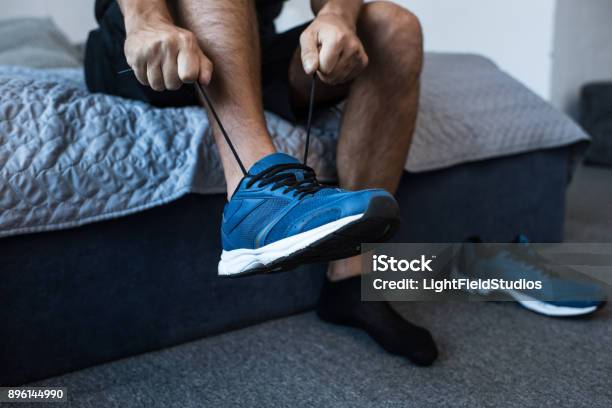 Man Tying Sneaker Laces Stock Photo - Download Image Now - Men, Shoe, Sports Shoe