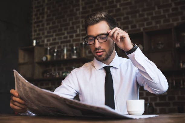 istock businessman at cafe reading newspaper 896145362