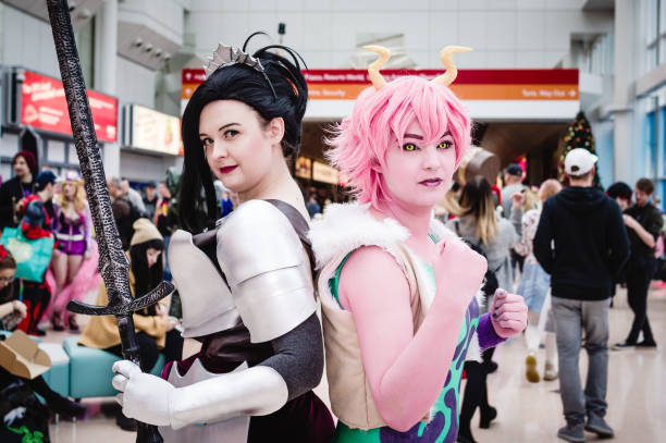 Cosplayers dressed as Momo Yaoyorozu and Mina Ashido from the anime My Hero Academia at Birmingham MCM Comic Con.
