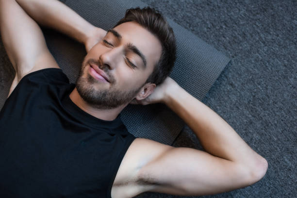 istock man on yoga mat with eyes closed 896153762