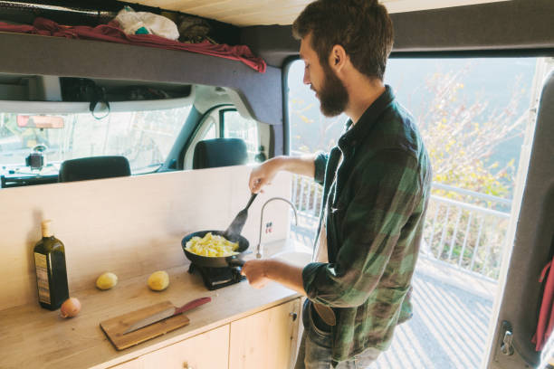 istock Man cooking in the van 896154550