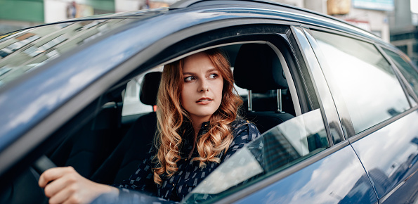 Shot of an attractive young woman driving a car in the city