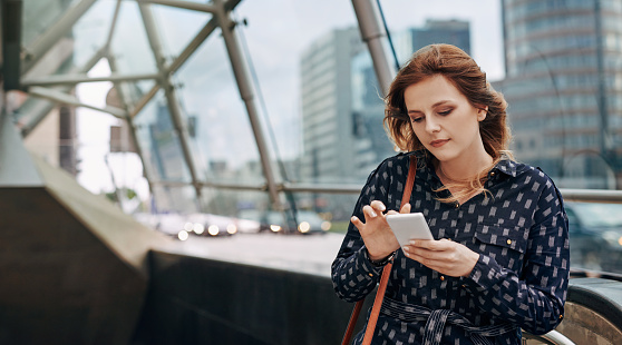 Shot of an attractive young woman using a mobile in the city