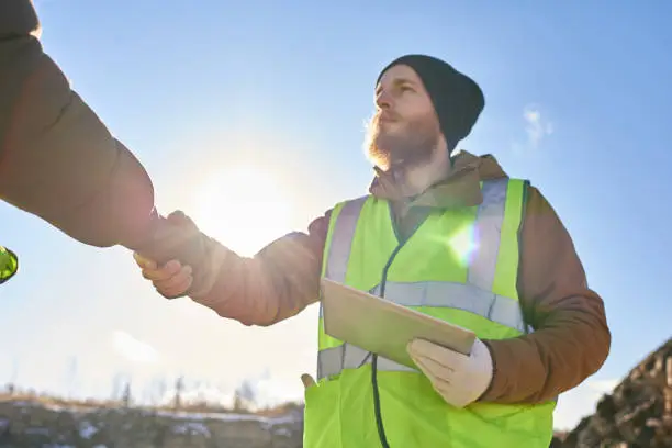 Photo of Bearded Miner Shaking Hands with Foreman