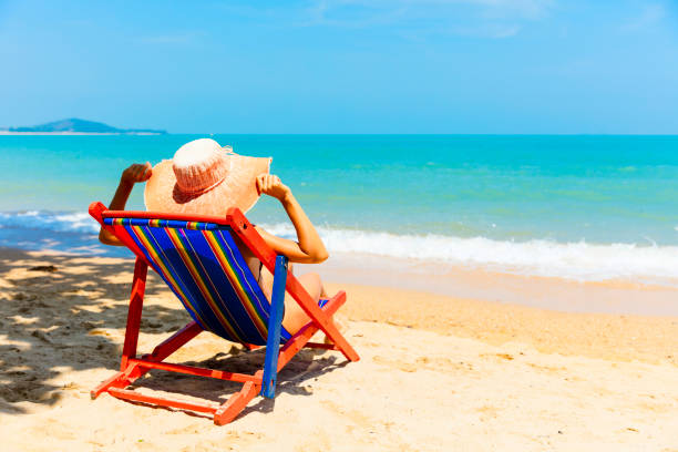 istock Woman sunbathing at tropical beach 896161838