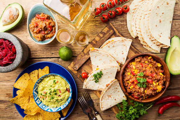 Mexican food mix Mexican food mix: nachos, fajitas, tortilla, guacamole and salsa sauces and ingredients over wooden background. Top view mexican culture food mexican cuisine fajita stock pictures, royalty-free photos & images