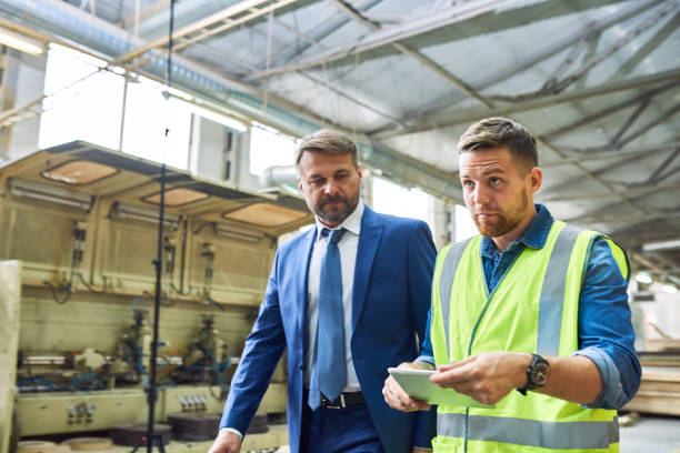 istock Mature Businessman Inspecting Modern Plant 896164244
