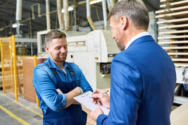 istock Senior Manager Talking to Worker at Factory 896164246
