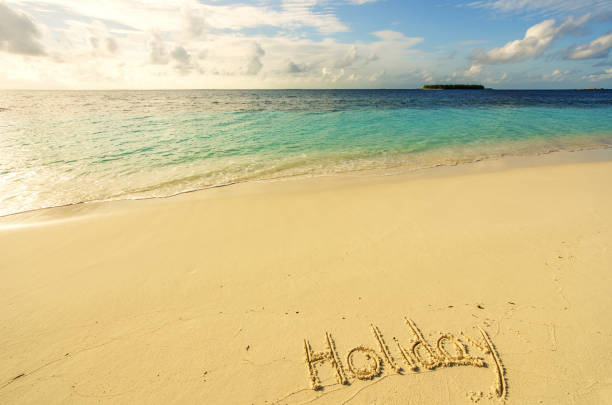 istock Holiday written on the golden sunset beach 896165522