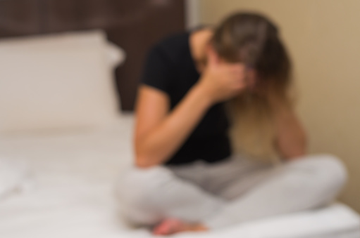 Great background blur with concept of depression, sad woman in bed.