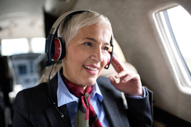 istock Senior woman in private jet airplane 896180384
