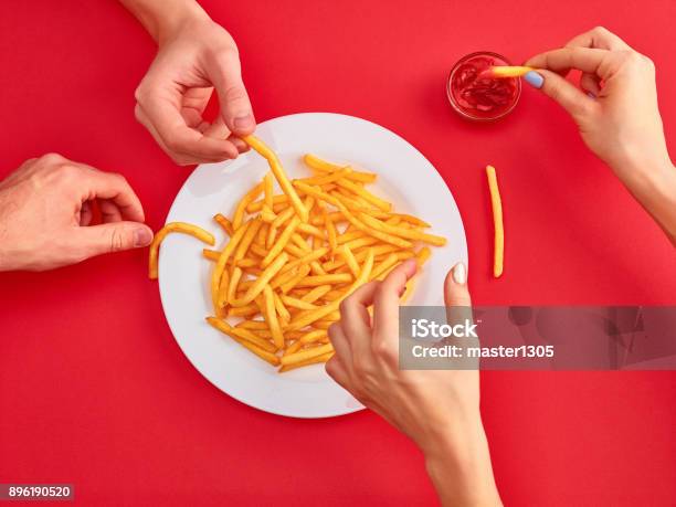 Young Woman Eating French Fries Potato With Ketchup In A Restaurant Stock Photo - Download Image Now