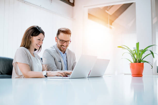 istock Business couple working together on project at modern startup office. 896190878