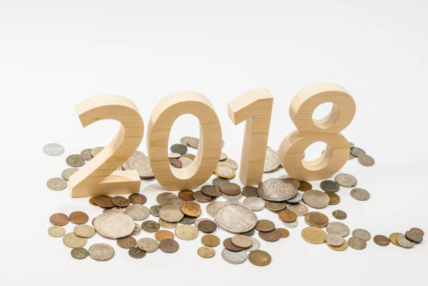 istock Figures 2018 are cut from solid wood with old vintage coins. New Year's concept. 896195426
