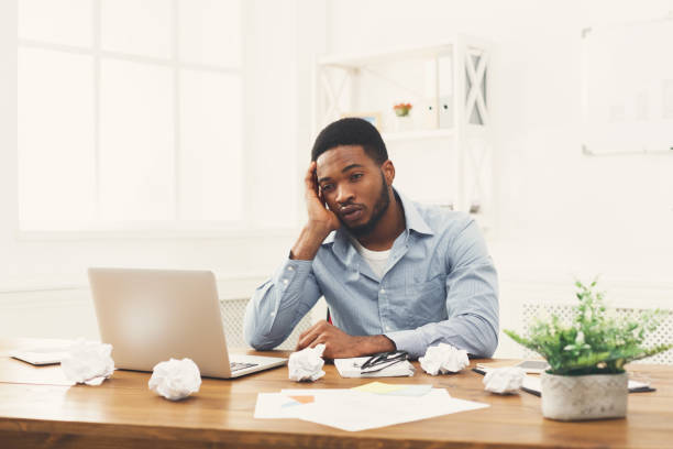 istock Overworking african-american employee at workplace 896198610