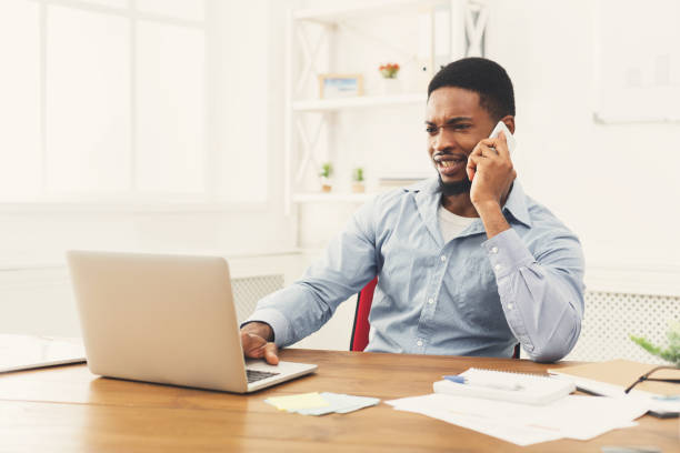 istock Young black businessman talking on mobile phone 896198922