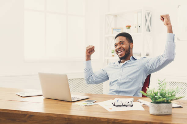 istock Happy businessman win. Winner, black man in office 896199120