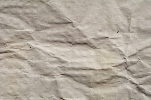 istock White crumpled paper for background. Brown and yellow textured grunge surface for design. 896199392