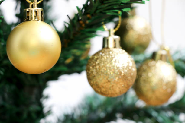 istock Gold decoration ball on green christmas tree with white background 896200876