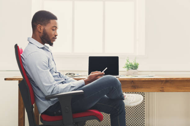 istock Young black businessman using mobile phone 896202058