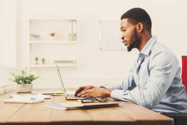 istock Young black businessman working with laptop 896202200