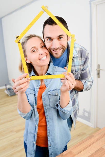 istock cheerful young couple making future project and renovating new home 896208468