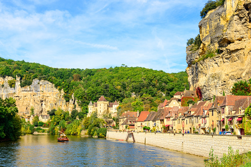 La Roque-Gageac, France - October 04, 2017: Street view from the historic village La Roque Gageac with Dordogne river, stone houses and chateau de la Malartrie in the region called the Dordogne in the Southwestern of France.