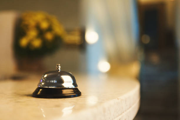 Hotel accommodation call bell on reception desk Hotel accommodation call bell on reception desk, contemporary interior, copy space bed and breakfast stock pictures, royalty-free photos & images