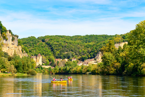 La Roque-Gageac, France - October 04, 2017: Street view from the historic village La Roque Gageac with Dordogne river, stone houses and chateau de la Malartrie in the region called the Dordogne in the Southwestern of France.