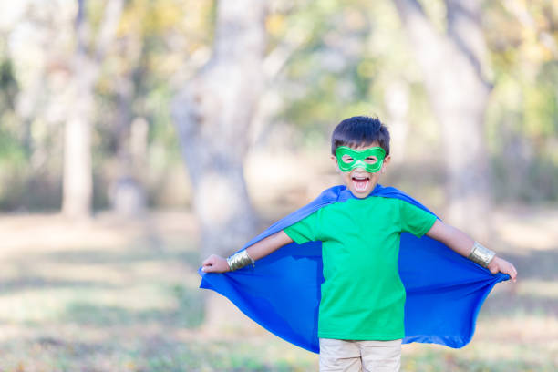 istock Little boy in superhero costume pretends to fly 896216618