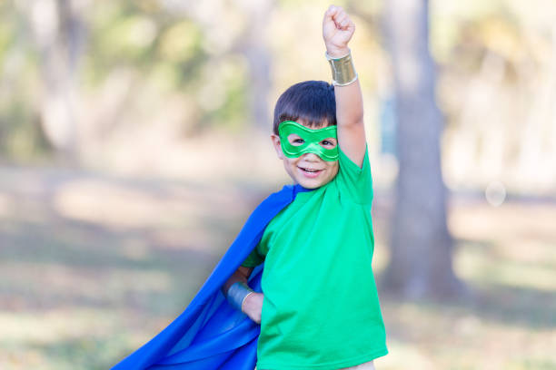 istock Little boy enjoys playing superhero outside 896216620