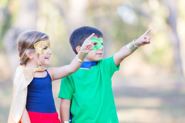 istock Little boy and girl enjoy playing superhero outside 896216632