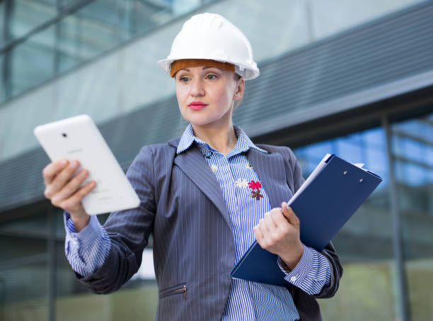 istock Businesswoman with documents touching screen tablet 896218040