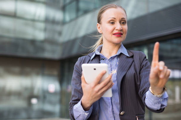 istock Employee woman with tablet touching finger on air 896218048