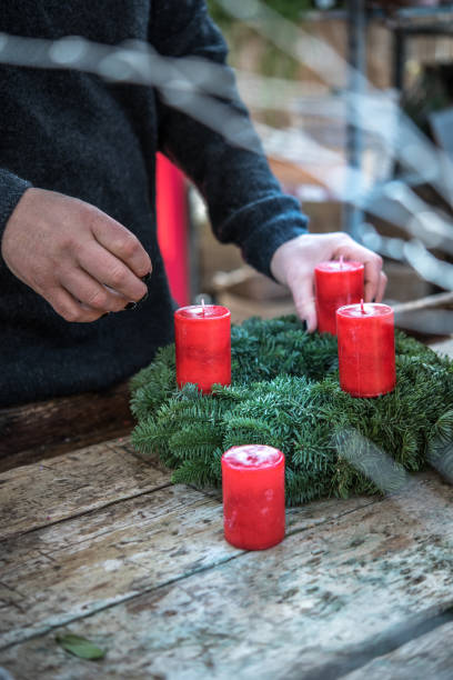 istock Woman Making Christmas Wreath with Candles 896221966