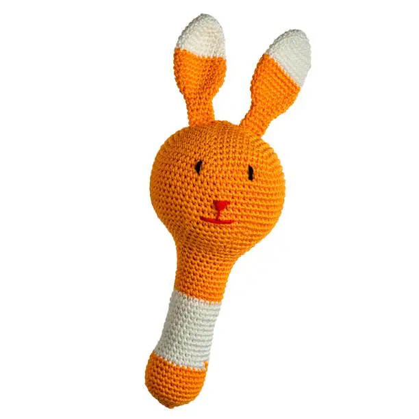 amigurumi crocheted rabbit rattle toy isolated on white background