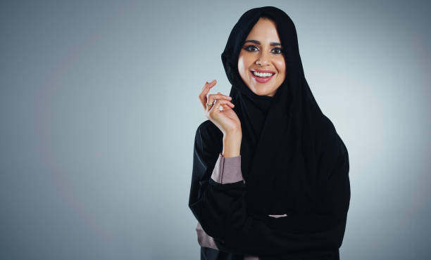 Confidence begins with a smile Studio portrait of a young muslim businesswoman against a grey background arab woman stock pictures, royalty-free photos & images