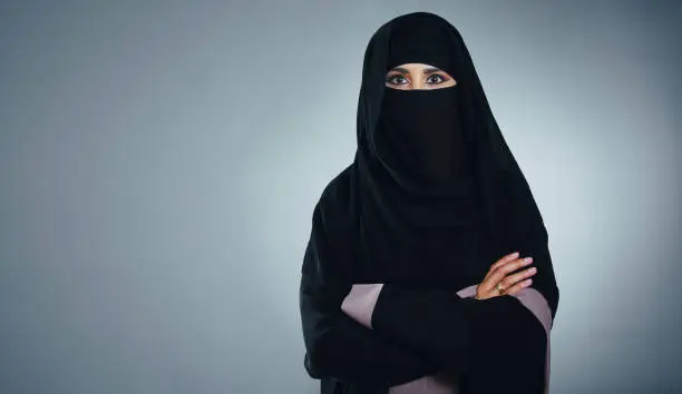 Studio portrait of a young muslim businesswoman against a grey background