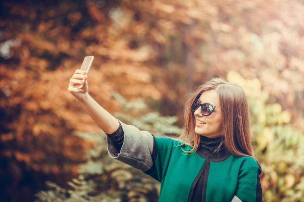 istock Smiling woman in glasses making selfie 896234856